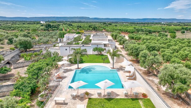 An aerial view of a property with a swimming pool, outdoor seating, and a garden. - Masseria Lamagrotte By Raro Rooms (Ostuni)