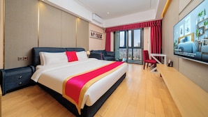 A modern hotel room with a large bed, a desk, and a TV. - Heefun International Apartment - Free Shuttle to Canton Fair (Guangzhou)