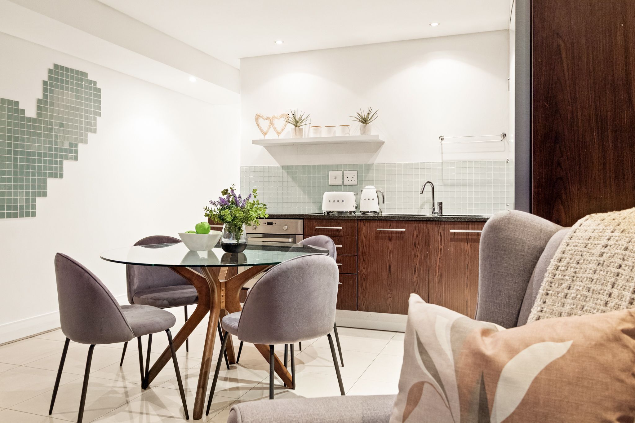 A modern kitchen with a dining area.