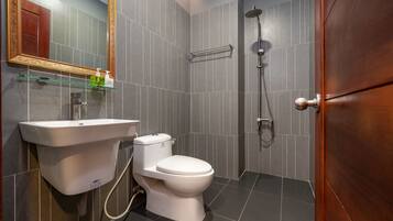A modern bathroom with a toilet, sink, and shower.