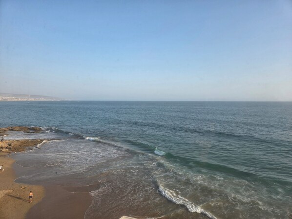 A beach with clear skies and calm waters. - Terrace at Azurblau (Taghazout)
