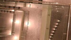 A modern interior with a glass railing and a reflective floor, suggesting a contemporary design. - Rosastays Hansi (Hansi)