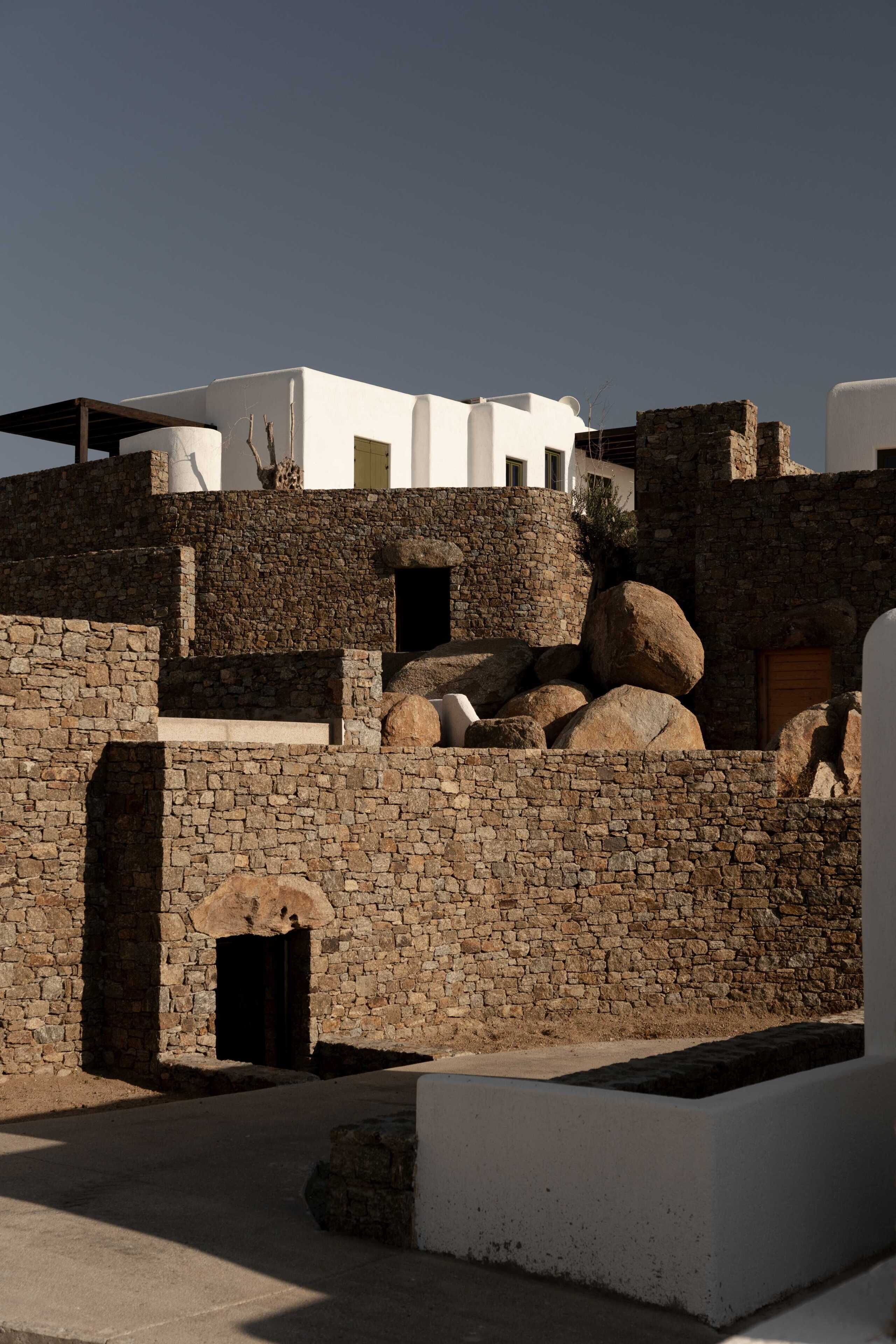 A stone building with a flat roof, a small door, and a window.