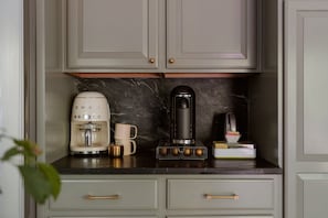 A kitchen with a coffee maker, a coffee machine, a mug, and a book on the counter. - Hot Tub, Fire Pit, Theater, Games & EV | Sleeps 8 (Barryville)