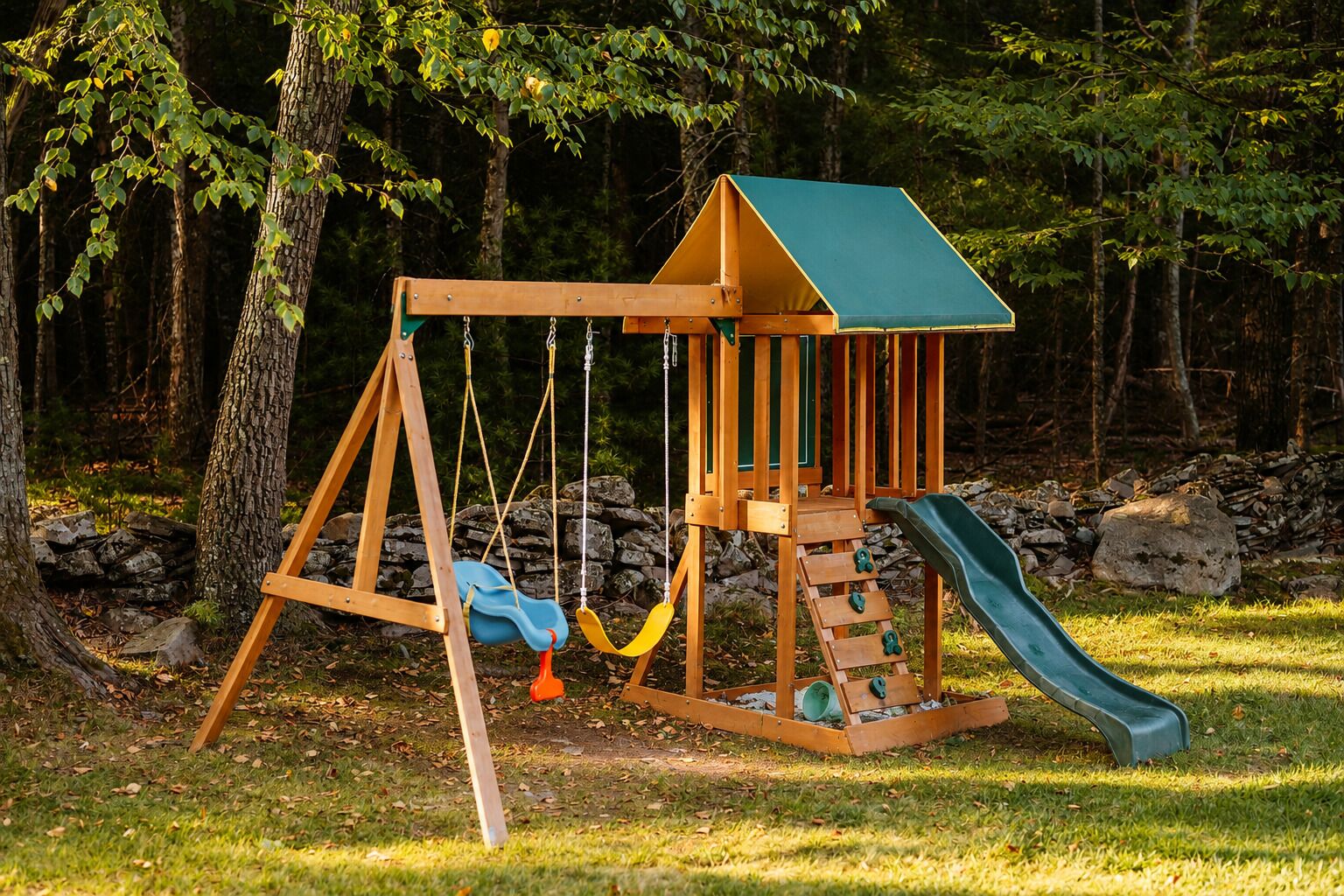 A wooden swing set with a slide, surrounded by trees and rocks.