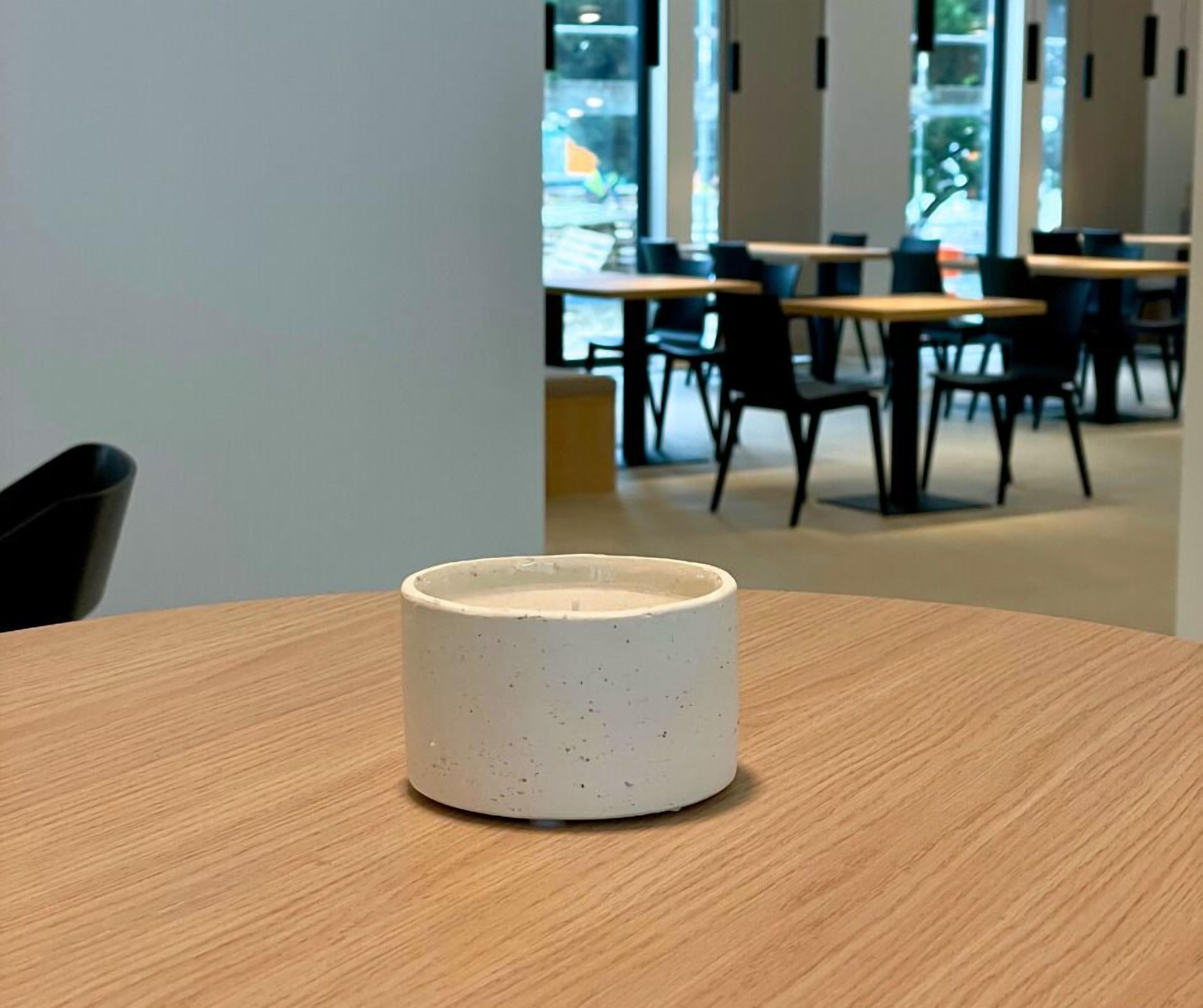 A wooden table with a white ceramic mug in the foreground.