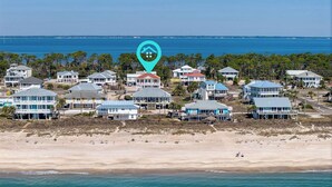 A coastal residential area with houses near the beach, a clear view of the ocean, and a location marker. - Makin' Memories 4 BR 4.5 Bath Home w/Private Pool, Elevator and Hot Tub (St. George Island)
