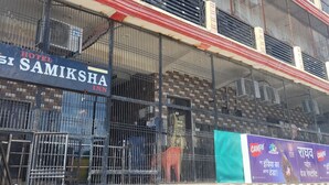 A multi-story building with a sign for 'Hotel Samiksha Inn' on the ground floor. - Hotel Samiksha Inn (Ayodhya)