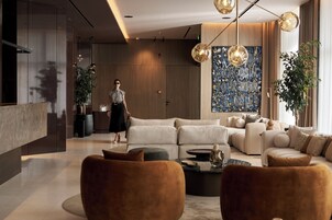 Una sala de estar moderna con un sofá modular, una mesa de centro y un cuadro abstracto de gran tamaño.