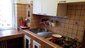 A kitchen with a sink, stove, and cabinets. - DI TUTTO E DI PIù (Milan)