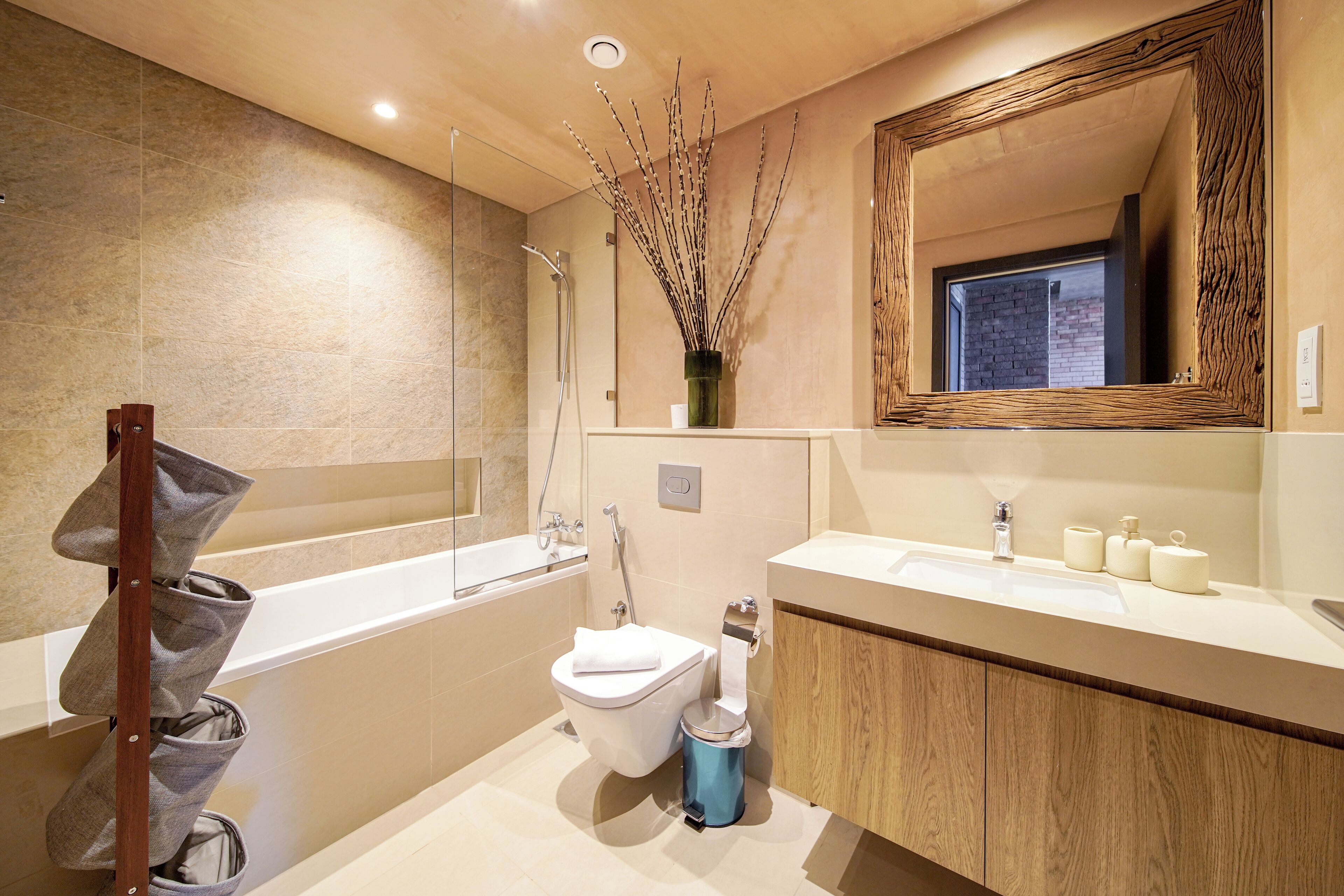 A modern bathroom with a bathtub, toilet, and sink.