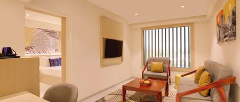 Una sala de estar moderna con un sofá, sillones, una mesa de centro y un televisor montado en la pared.