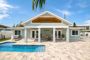 A two-story building with a pool, a covered patio, and a sign that reads 'SANTA KEY.'