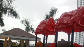 A playground with slides and climbing structures. - Condo with Water Views (Pasay City)