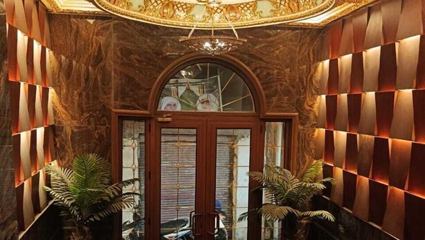 A grand entrance with a marble floor, a decorative ceiling, and a wooden door with glass panels. -  ALRashedy Hotel Powered by Boutique (Cairo)