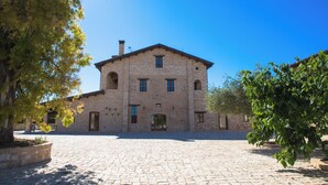 A historic building with a central courtyard, arched windows, and a symmetrical facade. - Casale Madonna Grande (Campomarino)