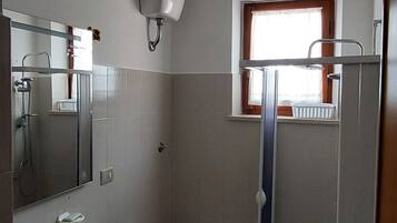 A bathroom with a sink, toilet, and shower.