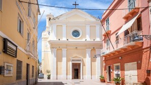 A church with a bell tower, a clock, and a circular window.