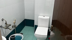 Ein kleines Badezimmer mit Toilette, Waschbecken und Dusche.