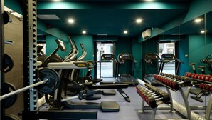 A gym with treadmills, ellipticals, and weight machines.