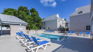 A pool area with lounge chairs and a swimming pool. - Casa Bonita Key West ~ by Rent Key West Vacations (Key West)
