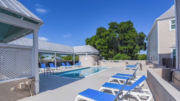 A rooftop pool area with lounge chairs and a covered seating area. - Casa Bonita Key West ~ by Rent Key West Vacations (Key West)