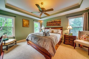 A bedroom with a large bed, a ceiling fan, a desk, and a chair. - 15 Mi to Louisville: Family Home w/ Private Yard! (Louisville)