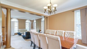A spacious room with a large wooden dining table, upholstered chairs, and a chandelier. - 4 Mi to Dulles Airport: Spacious D.c. Area Home (Herndon)