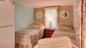 A bedroom with two beds, a dresser, a mirror, and a window with blinds. - Fish & Hike: Lakeside Poconos Retreat, Unit 4 (Bangor)