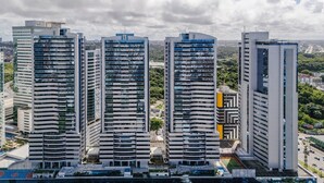 A high-rise building complex with multiple floors, surrounded by greenery and other buildings. - Beautiful Apartment 500m From Shopping Csp1207 (Salvador)