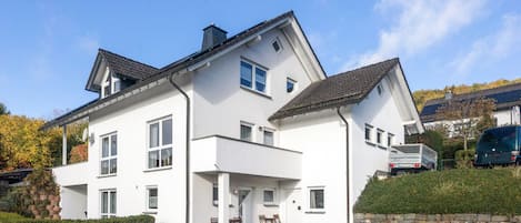 A two-story white building with multiple windows and a flat roof.