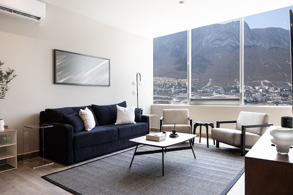 Comfortable seating area, framed by city and mountain scenery.