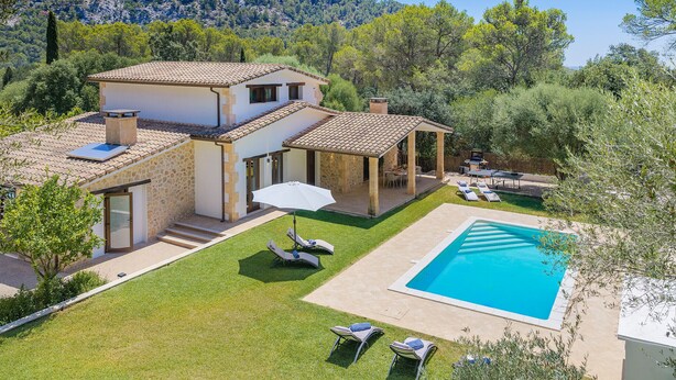 A house with a swimming pool, a patio with lounge chairs, and a view of the surrounding landscape. - VILLA SON TONI (Crestatx)