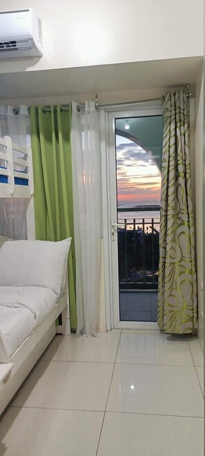 Basic Condo, 1 Bedroom, Balcony, Partial Sea View | Iron/ironing board, free WiFi, bed sheets