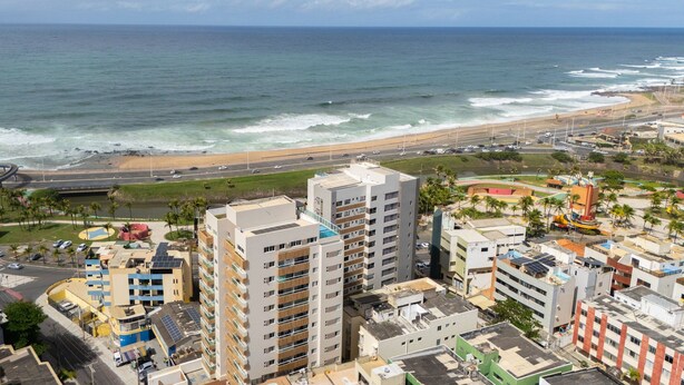 A coastal cityscape with high-rise buildings, a beach, and a highway. - Full Apartment w/ View and Balcony - Sol0404 (Salvador)