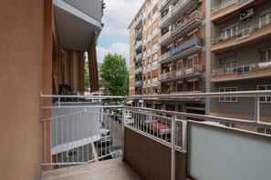 A multi-story residential building with balconies, a visible street below, and a tree in the background. - GuestHost - Comfortable recently renovated apartment of 75 sqm, perfect for 6 people, located on the first floor of a building with a lift (NOT suitable for disabled people).The property is located in the Trionfale district, a stone's throw from the Cipr (Rome)