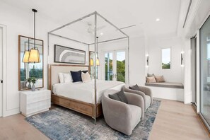 A modern bedroom with a four-poster bed, a bedside bench, a large mirror, and a view of the outdoors. - 30A Gulf View l Golf Cart l Pool l Rooftop Deck (Santa Rosa Beach)