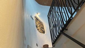 A staircase with a wooden ceiling and a black metal railing. - Stay in the tranquility of Badolato's ancient, atmospheric streets (Badolato)
