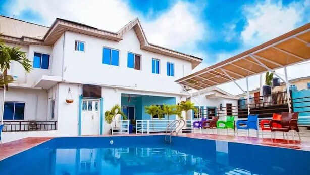 A two-story building with a swimming pool in the foreground. - The Kings Hotel and Suites  (Ibadan)