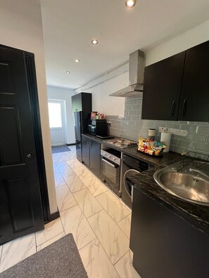 Fridge, stovetop, electric kettle, cookware/dishes/utensils