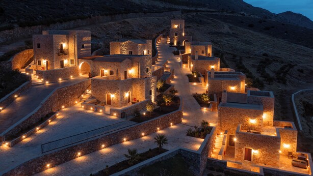 A stone-walled building complex with multiple levels, staircases, and pathways. - Anemos Suites Mani (East Mani)