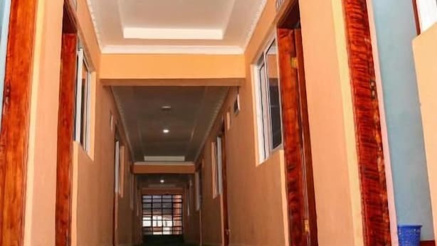 A corridor with a ceiling featuring recessed lighting and a central light fixture. - Paradise Point Resort Naivasha (Nyahururu)