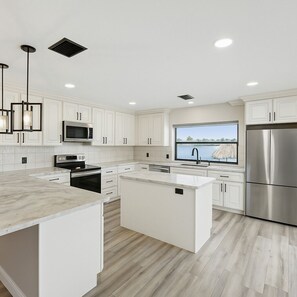 Fridge, microwave, oven, stovetop - Dolphin Cove Villa •Gulf Access Waterfront •Heated Pool & Hot Tub •Game Room (Cape Coral)