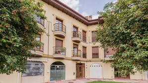 A multi-story building with balconies, a central entrance, and a well-maintained lawn. - Spectacular, Very Cozy and Bright Duplex (Cartes)