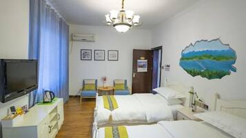 A hotel room with two beds, a TV, a desk, a chair, and a painting on the wall.