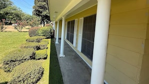 A building with a covered porch, columns, and large windows. - Parham Bridges #1 5 Bedroom 2 Bath (Jackson)