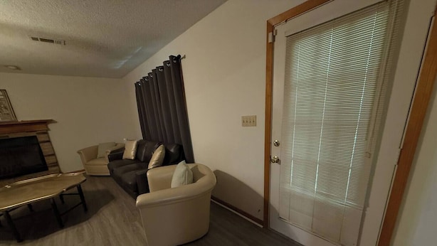 A living room with a sofa set, a TV, and a dining table. - Parham Bridges #1 5 Bedroom 2 Bath (Jackson)