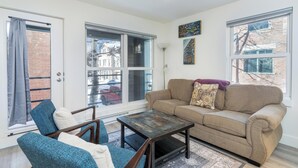 A living room with a sofa, two armchairs, a coffee table, and large windows. - Fall Line-Curate Telluride, Center of Town, Near Gondola, Parking Garage, HotTub (Telluride)