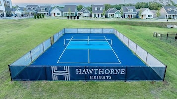 A tennis court with a net, surrounded by a fence, and labeled "HAWTHORNE HEIGHTS".