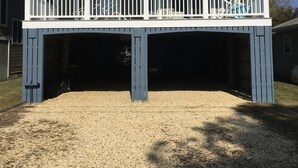 A two-story building with a covered front porch and a garage. - Spacious 7BR + 6-Car Parking | 2 Blocks from Beach (Bethany Beach)